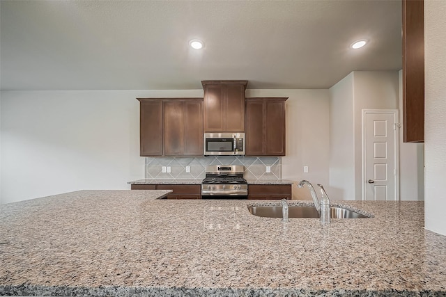2127 Port Jackson, Texas City, TX 77568 - kitchen featuring appliances with stainless steel finishes, decorative backsplash, recessed lighting, and light stone counters