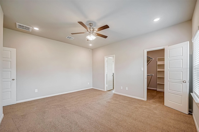 2127 Port Jackson, Texas City, TX 77568 - unfurnished bedroom featuring a walk in closet, light carpet, recessed lighting, a closet, and ceiling fan