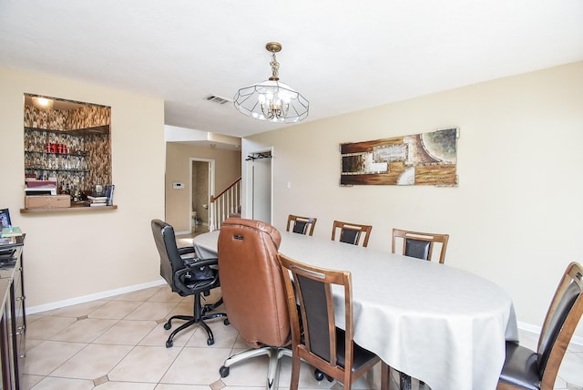 7719 Apache Plume Dr, Houston, TX 77071 - dining area with a chandelier, light tile patterned floors, and stairway