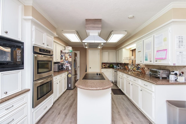 7719 Apache Plume Dr, Houston, TX 77071 - kitchen with black appliances, light wood-style flooring, a center island, white cabinetry, and crown molding