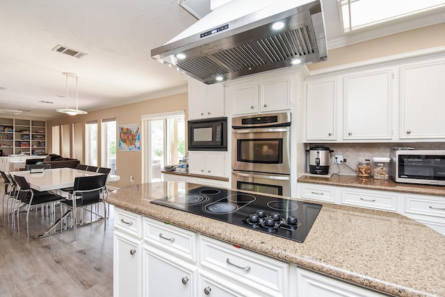 7719 Apache Plume Dr, Houston, TX 77071 - kitchen featuring exhaust hood, black appliances, white cabinets, crown molding, and light stone countertops