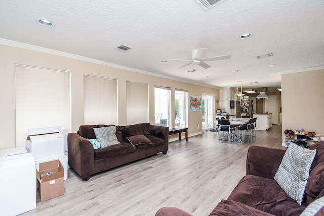 7719 Apache Plume Dr, Houston, TX 77071 - living area featuring crown molding, light wood finished floors, a textured ceiling, a ceiling fan, and recessed lighting