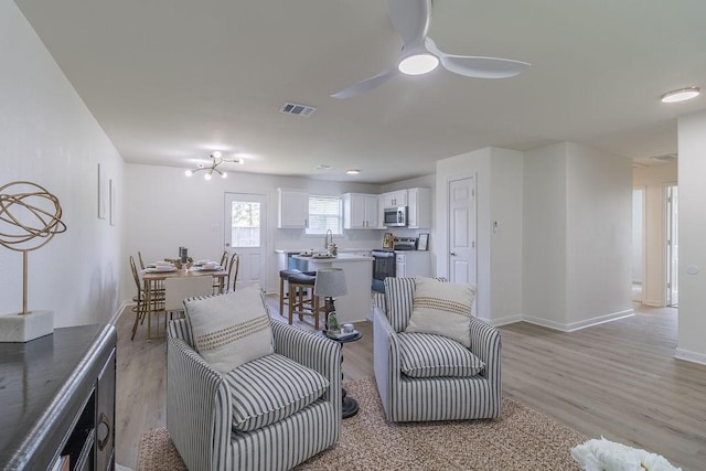 4310 Peppermint Hill Ln, Richmond, TX 77469 - living area featuring light wood-style floors and a ceiling fan