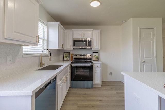 4310 Peppermint Hill Ln, Richmond, TX 77469 - kitchen with stainless steel appliances, white cabinetry, light wood-type flooring, light countertops, and tasteful backsplash