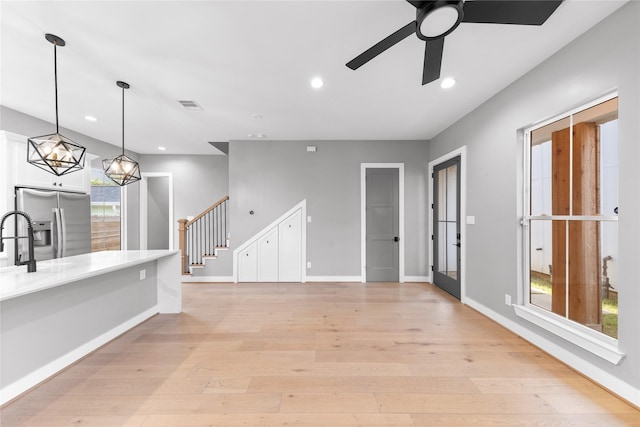 1412 Weiss St, Houston, TX 77009 - unfurnished living room featuring light wood-style floors, stairway, recessed lighting, and ceiling fan