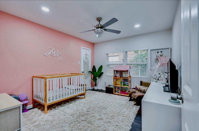8614 Linkpass Ln, Houston, TX 77025 - bedroom with recessed lighting, wood finished floors, a nursery area, and a ceiling fan