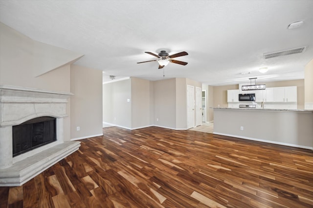 2411 Lacyberry St, Houston, TX 77080 - unfurnished living room featuring wood finished floors, ceiling fan, and a high end fireplace