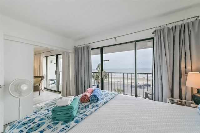 7310 Seawall Blvd Unit 404, Galveston, TX 77551 - bedroom featuring access to exterior, wood finished floors, and a water view