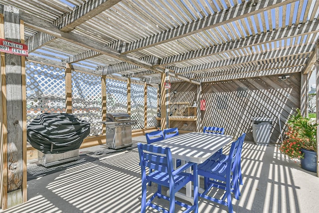7310 Seawall Blvd Unit 404, Galveston, TX 77551 - view of patio featuring a pergola, grilling area, and outdoor dining area