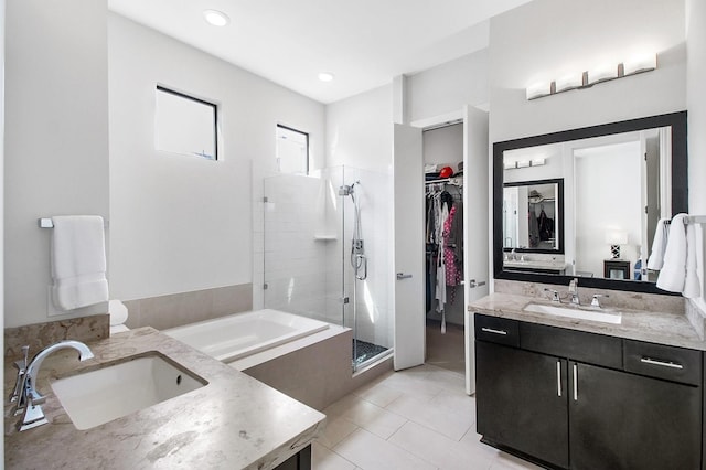 2205 Colorado St, Houston, TX 77007 - full bath featuring vanity, a stall shower, a bath, tile patterned flooring, and a spacious closet