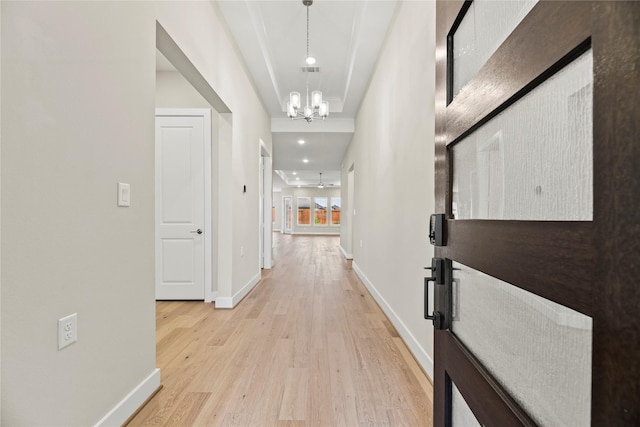 9418 Whispering Bald Cypress Ct, Cypress, TX 77433 - corridor with a chandelier and light wood-style flooring