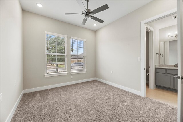 9418 Whispering Bald Cypress Ct, Cypress, TX 77433 - unfurnished bedroom with light carpet, recessed lighting, ensuite bathroom, and ceiling fan