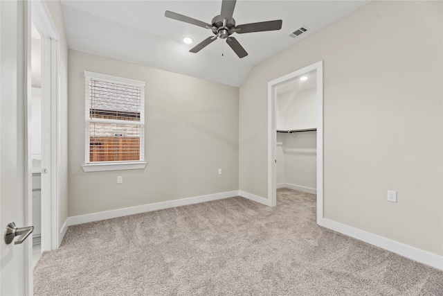 9418 Whispering Bald Cypress Ct, Cypress, TX 77433 - unfurnished bedroom featuring carpet flooring, a spacious closet, lofted ceiling, and ceiling fan