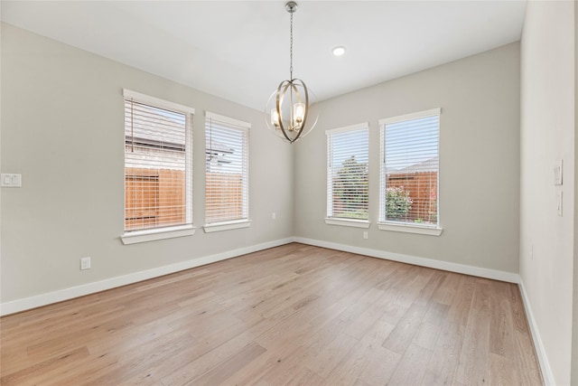 9418 Whispering Bald Cypress Ct, Cypress, TX 77433 - unfurnished room with a chandelier and light wood-type flooring