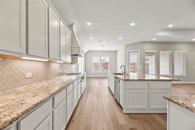 9418 Whispering Bald Cypress Ct, Cypress, TX 77433 - kitchen with appliances with stainless steel finishes, light wood-style floors, decorative backsplash, white cabinetry, and recessed lighting