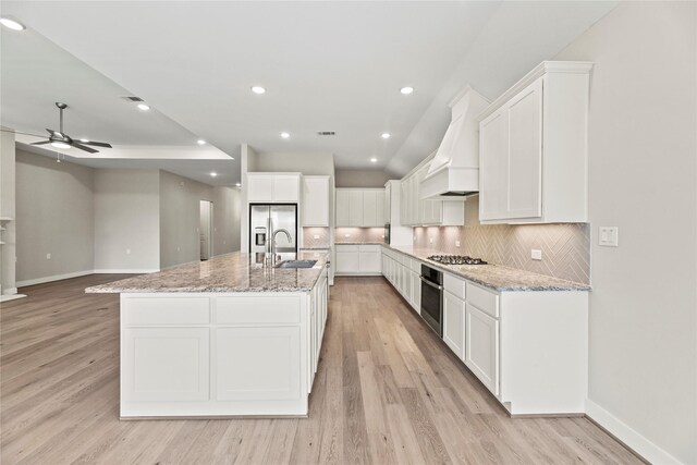 9418 Whispering Bald Cypress Ct, Cypress, TX 77433 - kitchen with appliances with stainless steel finishes, ceiling fan, white cabinets, light wood-style flooring, and recessed lighting
