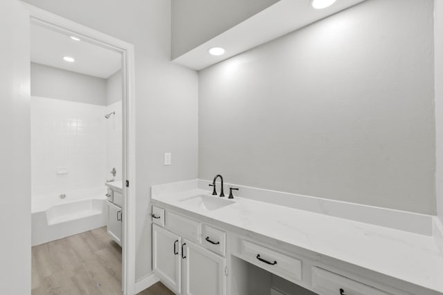 550 Wilcrest Dr Unit 550, Houston, TX 77042 - bathroom with vanity, wood finished floors, shower / bathtub combination, and recessed lighting