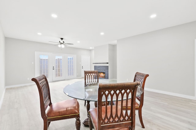550 Wilcrest Dr Unit 550, Houston, TX 77042 - dining room with ceiling fan, a warm lit fireplace, recessed lighting, and light wood-type flooring