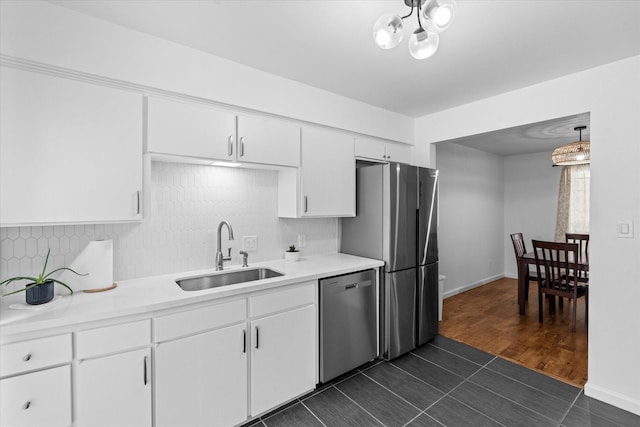6697 De Moss Dr Unit 697, Houston, TX 77074 - kitchen featuring stainless steel appliances, tasteful backsplash, light countertops, and white cabinetry
