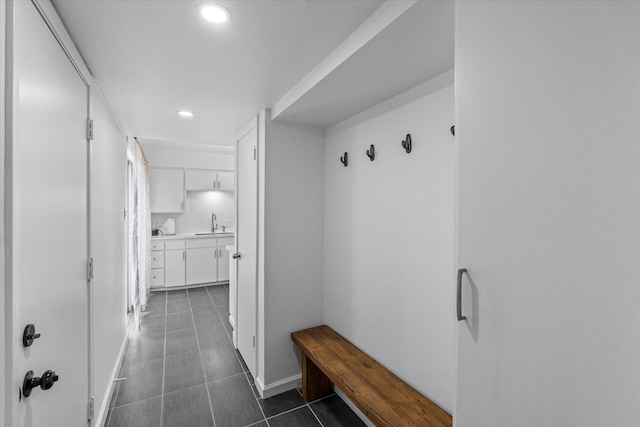 6697 De Moss Dr Unit 697, Houston, TX 77074 - mudroom with dark tile patterned floors and recessed lighting