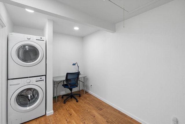6697 De Moss Dr Unit 697, Houston, TX 77074 - washroom featuring stacked washing machine and dryer, light wood finished floors, attic access, and recessed lighting