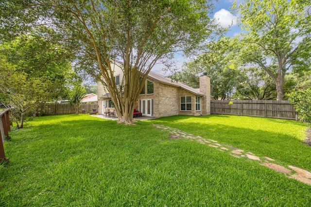 3403 Spring Arbor Ln, Sugar Land, TX 77479 - fenced backyard with french doors and a patio