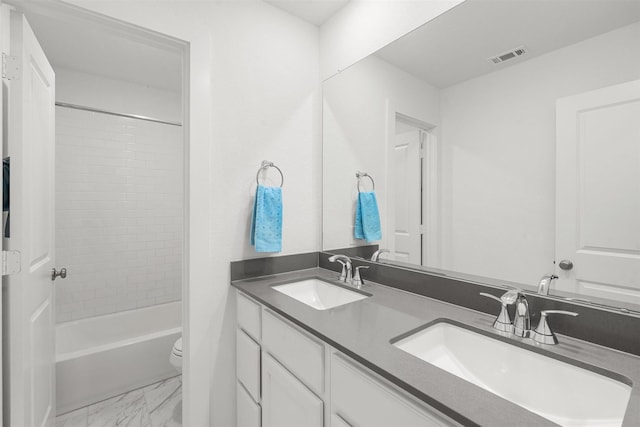 18247 Lakepoint Ridge Ln, Cypress, TX 77433 - bathroom featuring double vanity, marble look tiles, and shower / washtub combination