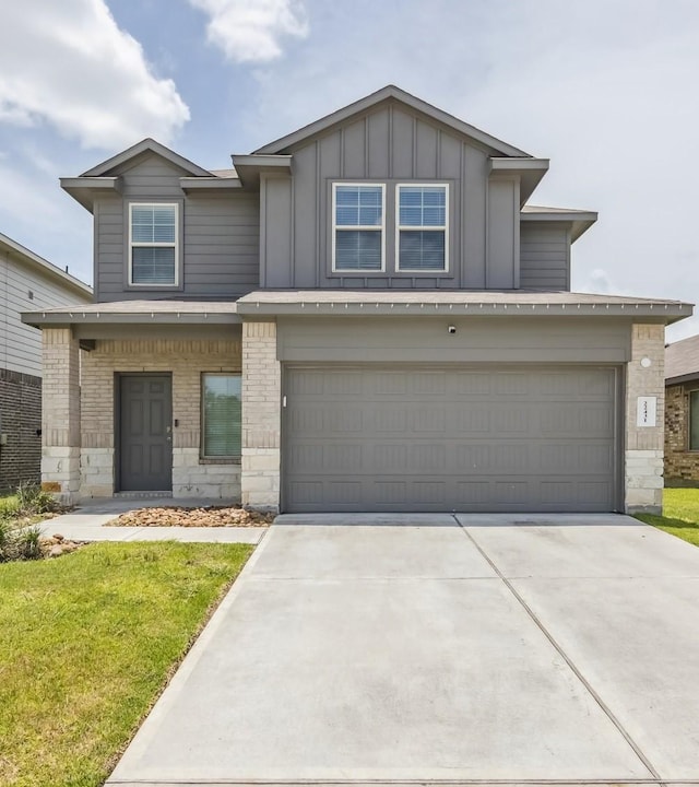 22431 Gilded Peak Ln, Spring, TX 77373 - view of front of house featuring board and batten siding, driveway, a front lawn, and stone siding
