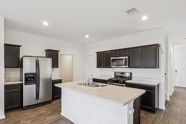 22431 Gilded Peak Ln, Spring, TX 77373 - kitchen with appliances with stainless steel finishes, light countertops, dark wood-style floors, an island with sink, and recessed lighting