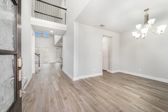28702 Casen Ranch Ln, Fulshear, TX 77441 - foyer entrance with a chandelier and wood finished floors