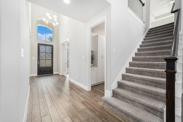 28702 Casen Ranch Ln, Fulshear, TX 77441 - entryway with stairway, light wood-style flooring, a chandelier, and recessed lighting