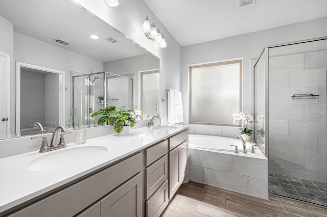 28702 Casen Ranch Ln, Fulshear, TX 77441 - full bath with a stall shower, double vanity, a garden tub, and wood finished floors