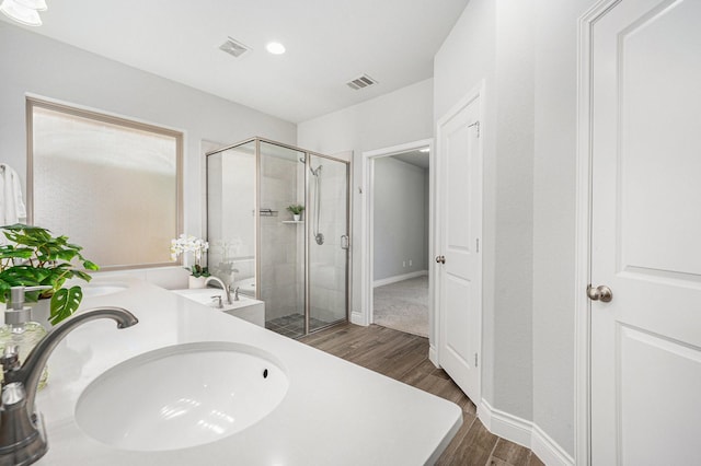 28702 Casen Ranch Ln, Fulshear, TX 77441 - bathroom featuring wood finished floors, a shower stall, double vanity, and recessed lighting