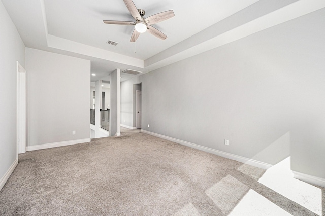 28702 Casen Ranch Ln, Fulshear, TX 77441 - unfurnished bedroom featuring carpet floors, a tray ceiling, and a ceiling fan