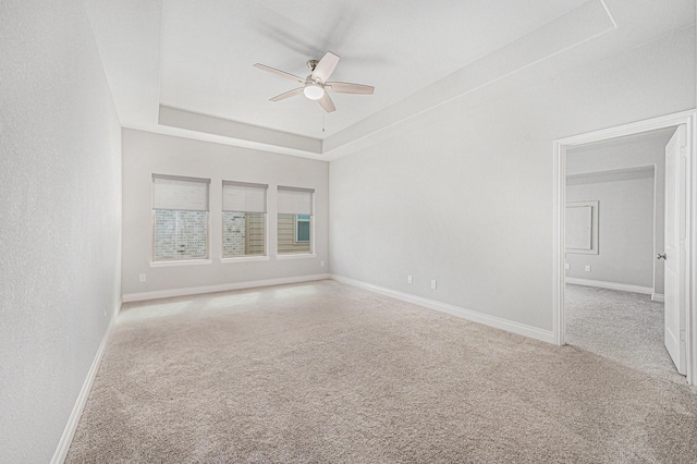 28702 Casen Ranch Ln, Fulshear, TX 77441 - empty room with a ceiling fan, carpet flooring, and a tray ceiling
