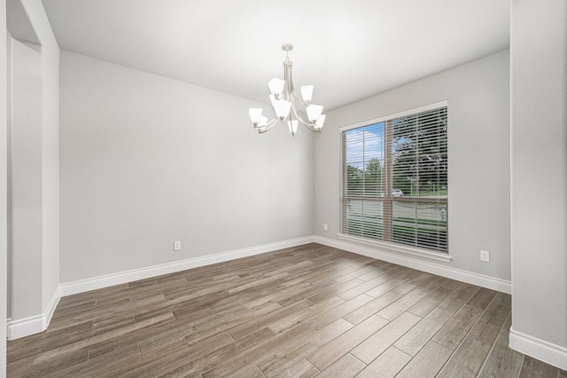 28702 Casen Ranch Ln, Fulshear, TX 77441 - empty room featuring a chandelier and wood finished floors