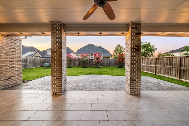 28702 Casen Ranch Ln, Fulshear, TX 77441 - patio terrace at dusk featuring a ceiling fan, a fenced backyard, and a patio area