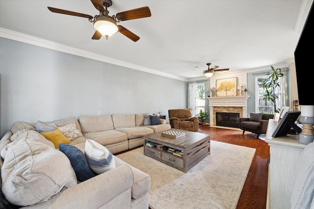12511 Wealdstone Dr, Tomball, TX 77377 - living room with a ceiling fan, a fireplace, wood finished floors, and ornamental molding