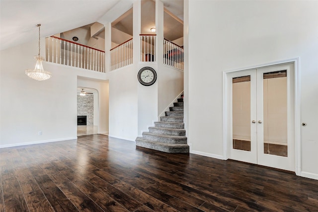 13351 Arlon Trl, Houston, TX 77082 - unfurnished living room featuring high vaulted ceiling, wood finished floors, french doors, stairway, and ceiling fan