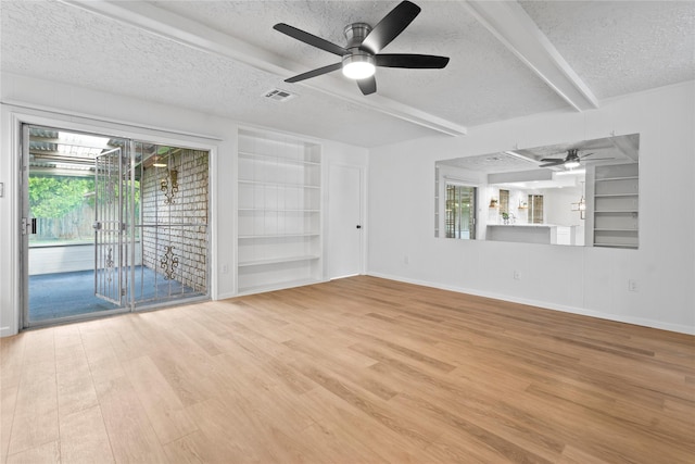 7019 Pyron Way, Houston, TX 77036 - unfurnished room featuring a textured ceiling, ceiling fan, wood finished floors, built in features, and beam ceiling