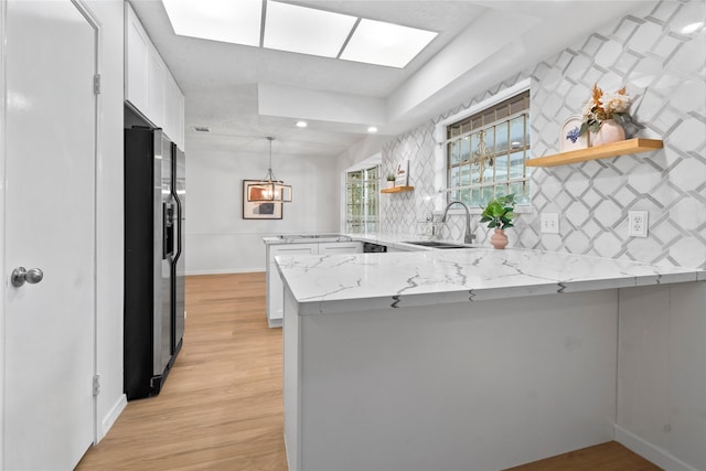 7019 Pyron Way, Houston, TX 77036 - kitchen with refrigerator with ice dispenser, a peninsula, open shelves, white cabinetry, and recessed lighting