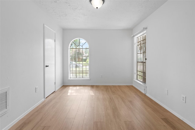 7019 Pyron Way, Houston, TX 77036 - empty room featuring light wood finished floors and a textured ceiling