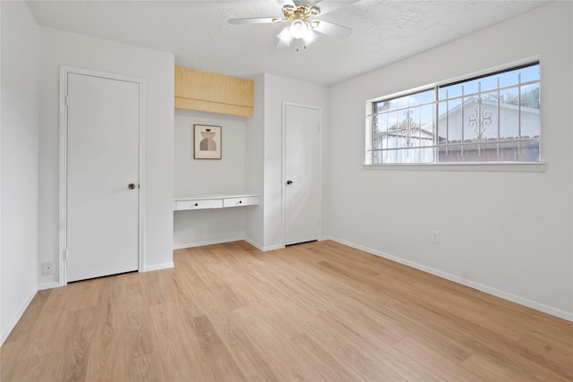 7019 Pyron Way, Houston, TX 77036 - unfurnished bedroom with light wood-style floors and a ceiling fan