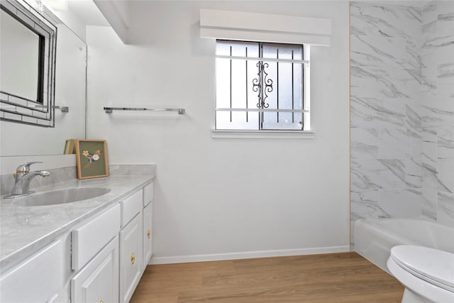 7019 Pyron Way, Houston, TX 77036 - full bathroom featuring vanity, wood finished floors, and washtub / shower combination