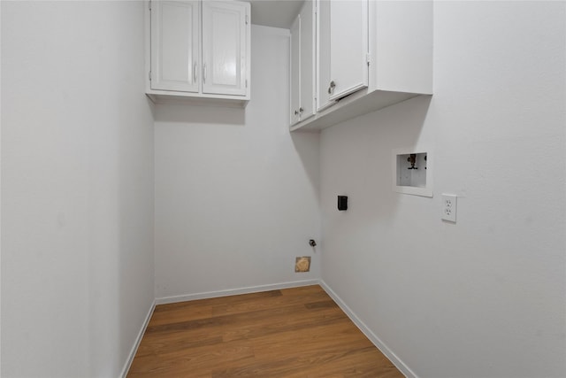 7019 Pyron Way, Houston, TX 77036 - laundry room featuring cabinet space, washer hookup, and wood finished floors