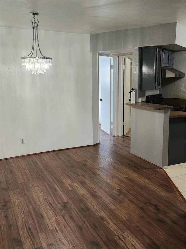 10811 Richmond Ave Unit 40, Houston, TX 77042 - unfurnished dining area featuring wood finished floors and a chandelier