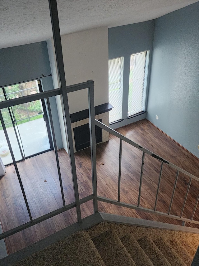 10811 Richmond Ave Unit 40, Houston, TX 77042 - stairs featuring wood finished floors and a textured ceiling