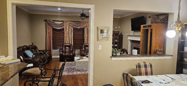 5322 Norborne Ln, Houston, TX 77069 - dining room featuring wood finished floors, ceiling fan, crown molding, and a fireplace