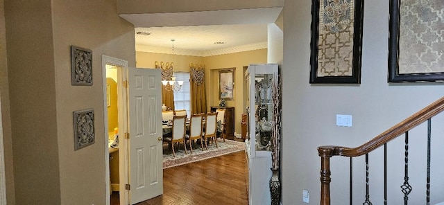 5322 Norborne Ln, Houston, TX 77069 - hallway with a chandelier, ornamental molding, dark wood-style flooring, and stairs