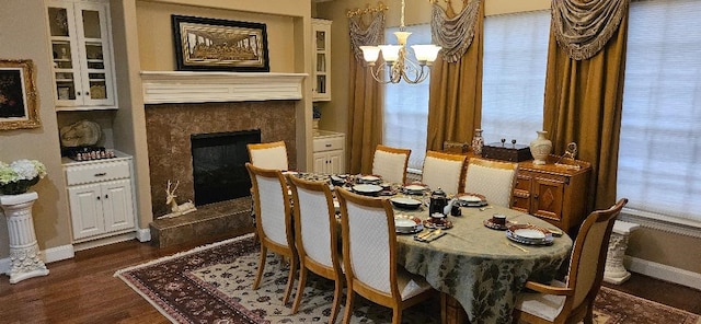 5322 Norborne Ln, Houston, TX 77069 - dining area with dark wood-style flooring, a chandelier, and a tiled fireplace